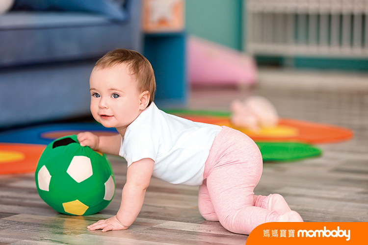 Cute baby playing with ball at home